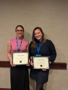 Monica and Olivia holding award certificates